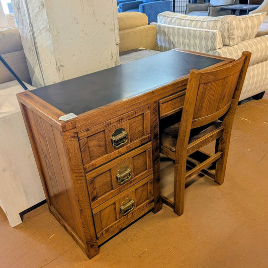 Wooden desk with chair in a furniture store setting