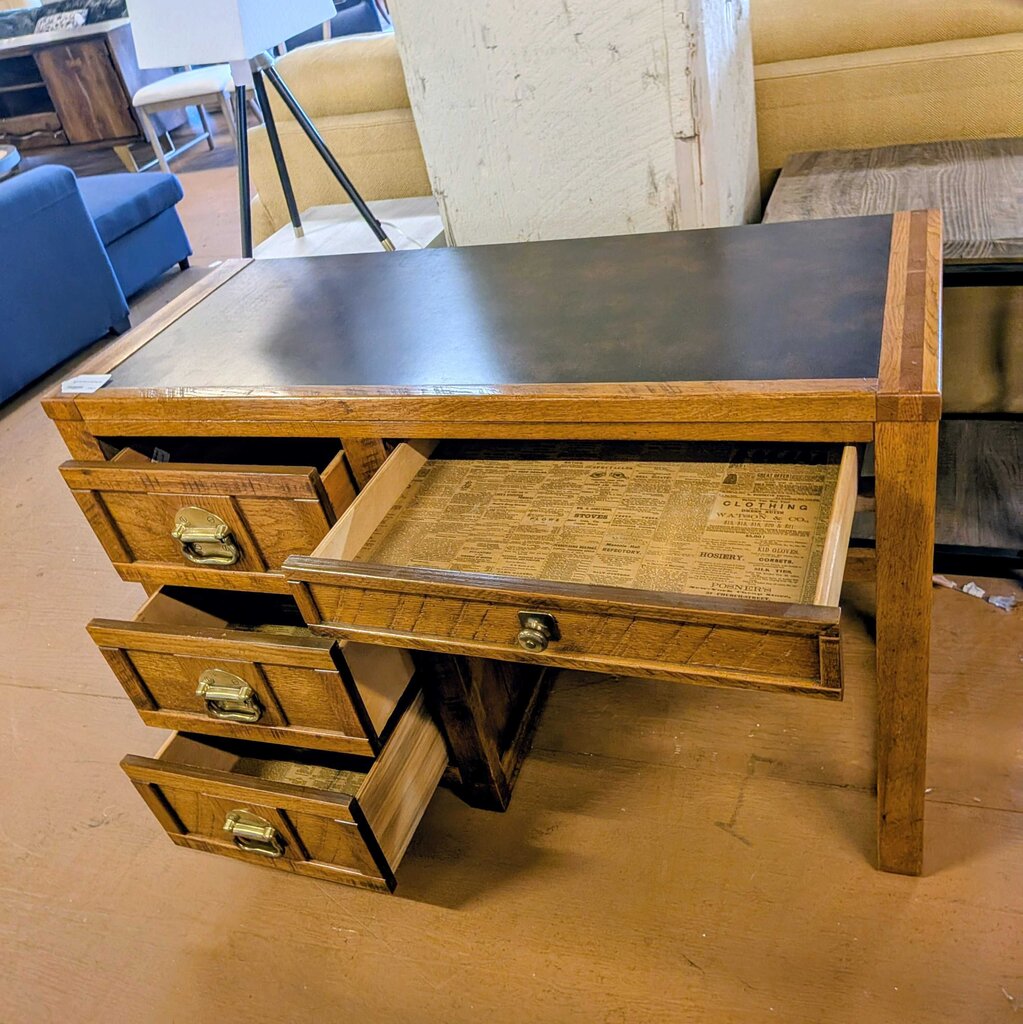 Wooden desk with open drawer in a room setting
