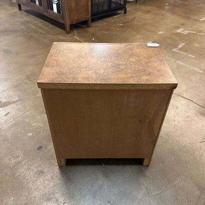 Wooden box on a concrete floor with a label