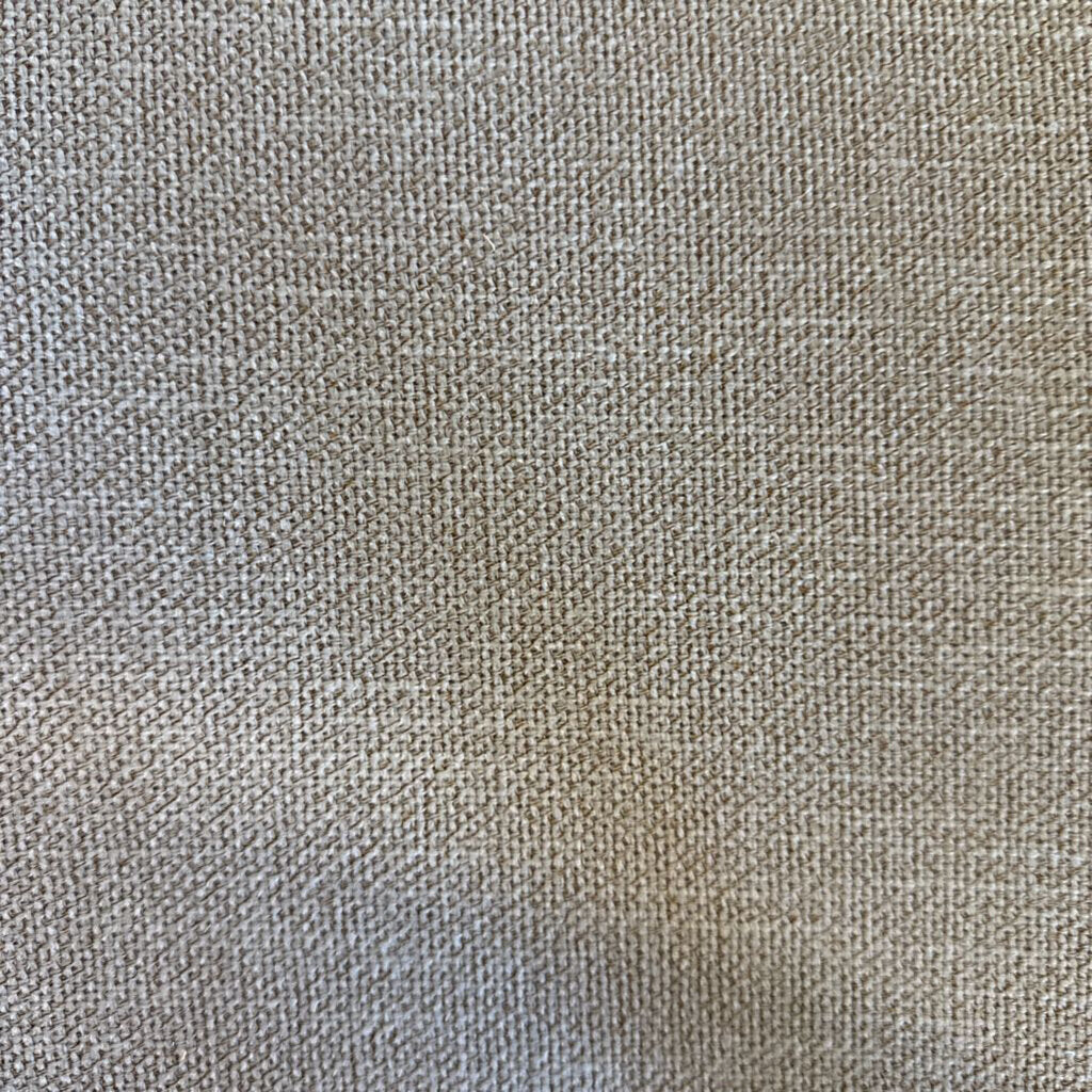 Close-up of a textured beige fabric surface