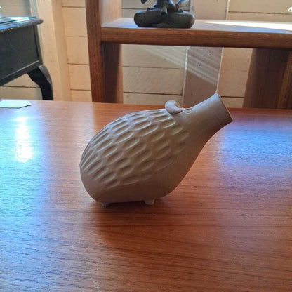 White textured vase on a wooden table