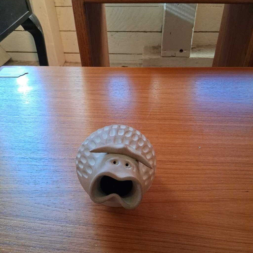 Hedgehog-shaped object on a wooden table