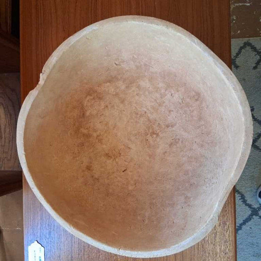 Round stone object on a wooden surface