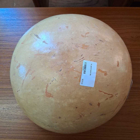 Round fruit with a label on a wooden surface