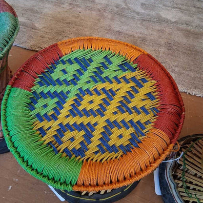 Colorful woven basket with a geometric pattern on a wooden surface