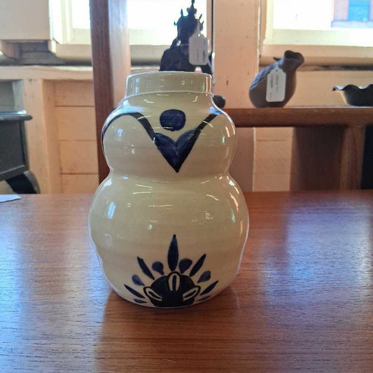 Ceramic jar with blue floral designs on a wooden table