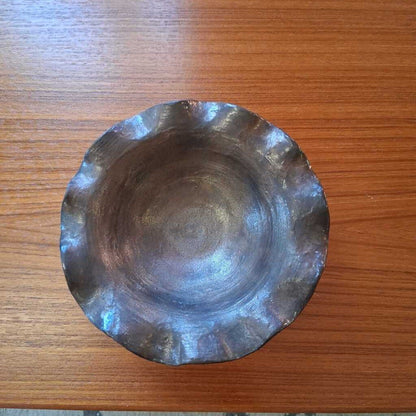 Metallic bowl on a wooden surface