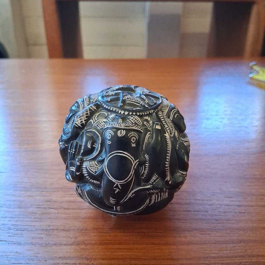 Decorative black ball with white patterns on a wooden table