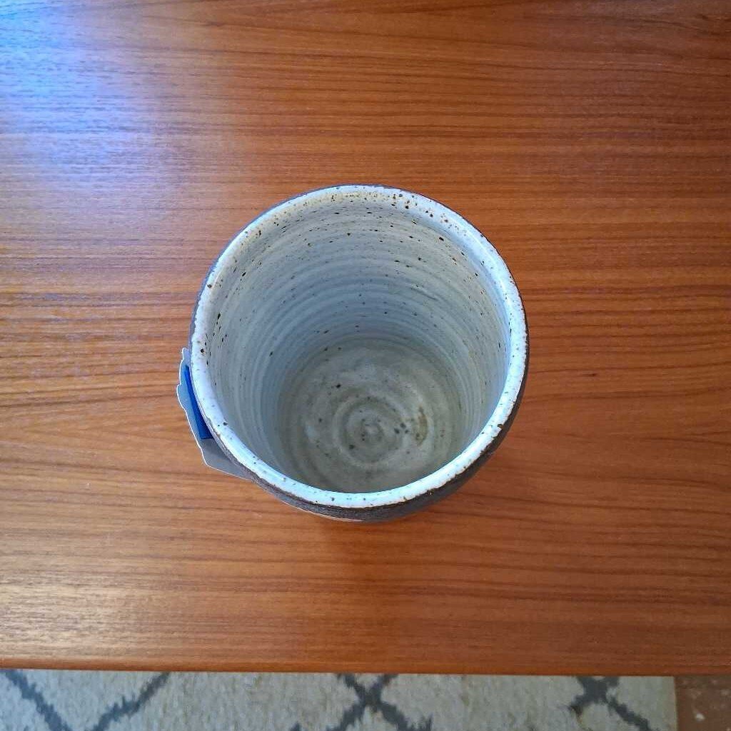 Ceramic cup with two-tone design on a wooden table