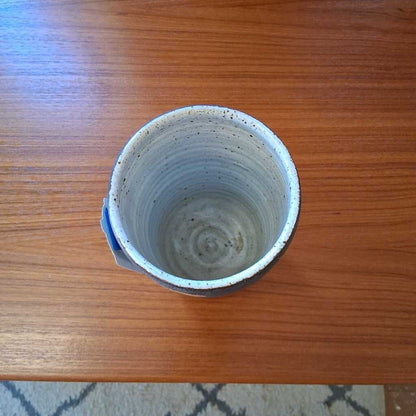 Ceramic cup with two-tone design on a wooden table