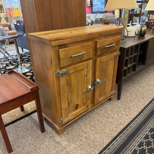 Wooden sideboard with drawers and doors in a room setting