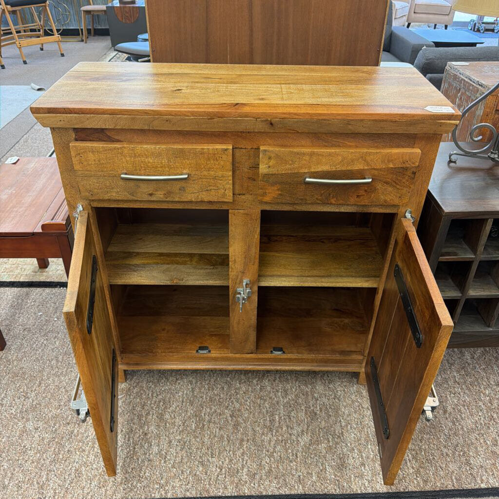 Wooden cabinet with open doors on a carpeted floor