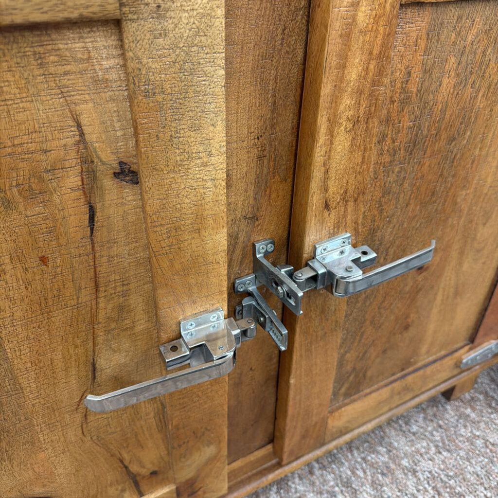 Close-up of wooden cabinet doors with metal hinges and locks.
