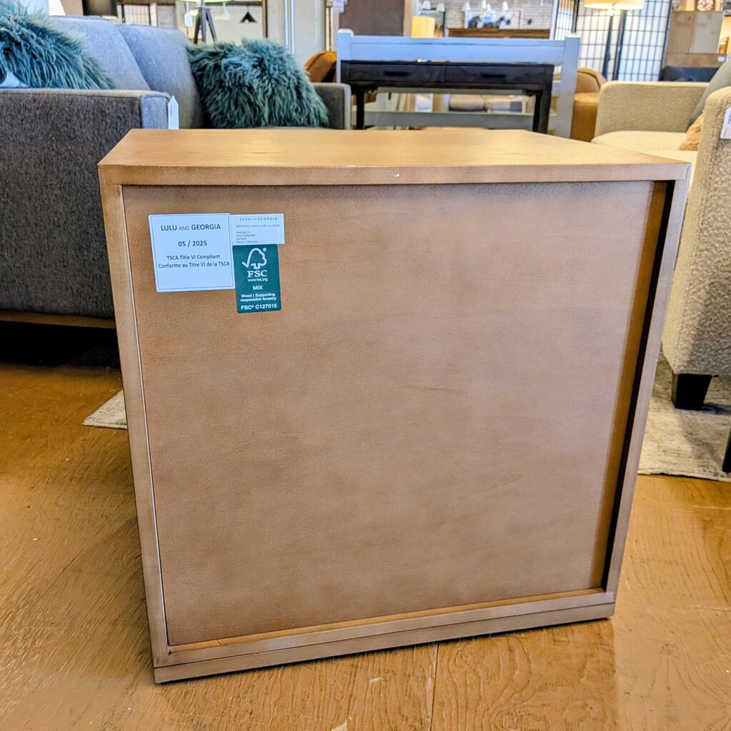 Wooden furniture piece with a label on a wooden floor