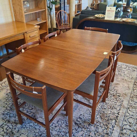 Wooden dining table with chairs in a room setting