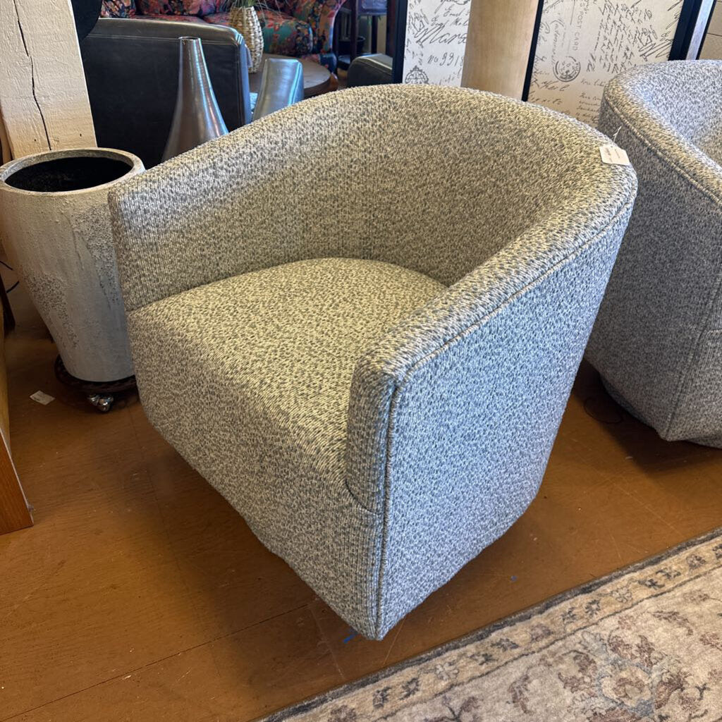 Textured armchair on a wooden floor with a patterned rug