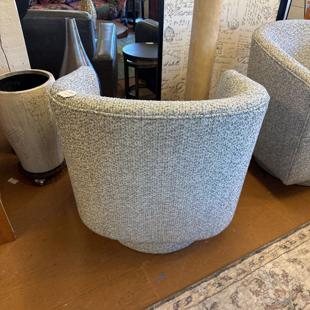 Textured armchair on a wooden floor with a patterned rug