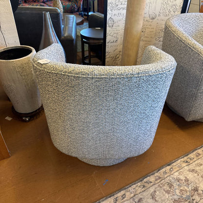 Textured armchair on a wooden floor with a patterned rug