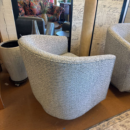 Textured armchair in a room with patterned walls and furniture.