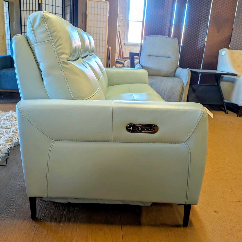 Light blue recliner chair with control panel in a living room setting