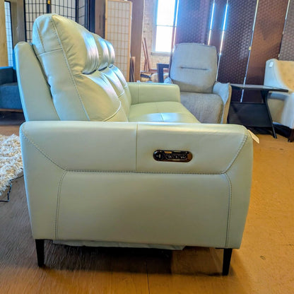 Light blue recliner chair with control panel in a living room setting