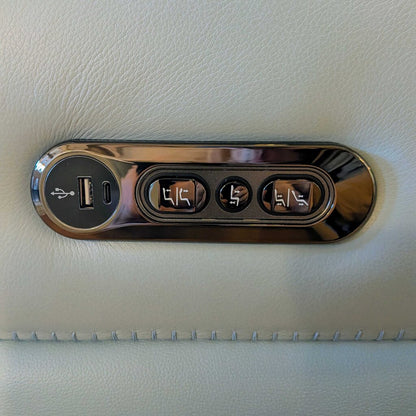 Car console with USB port and multiple outlets on a beige leather surface