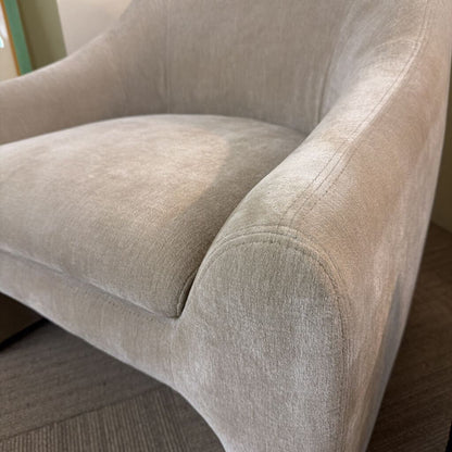 Close-up of a beige armchair with a soft texture.