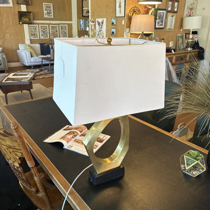 Table lamp with a white shade on a desk in an office setting