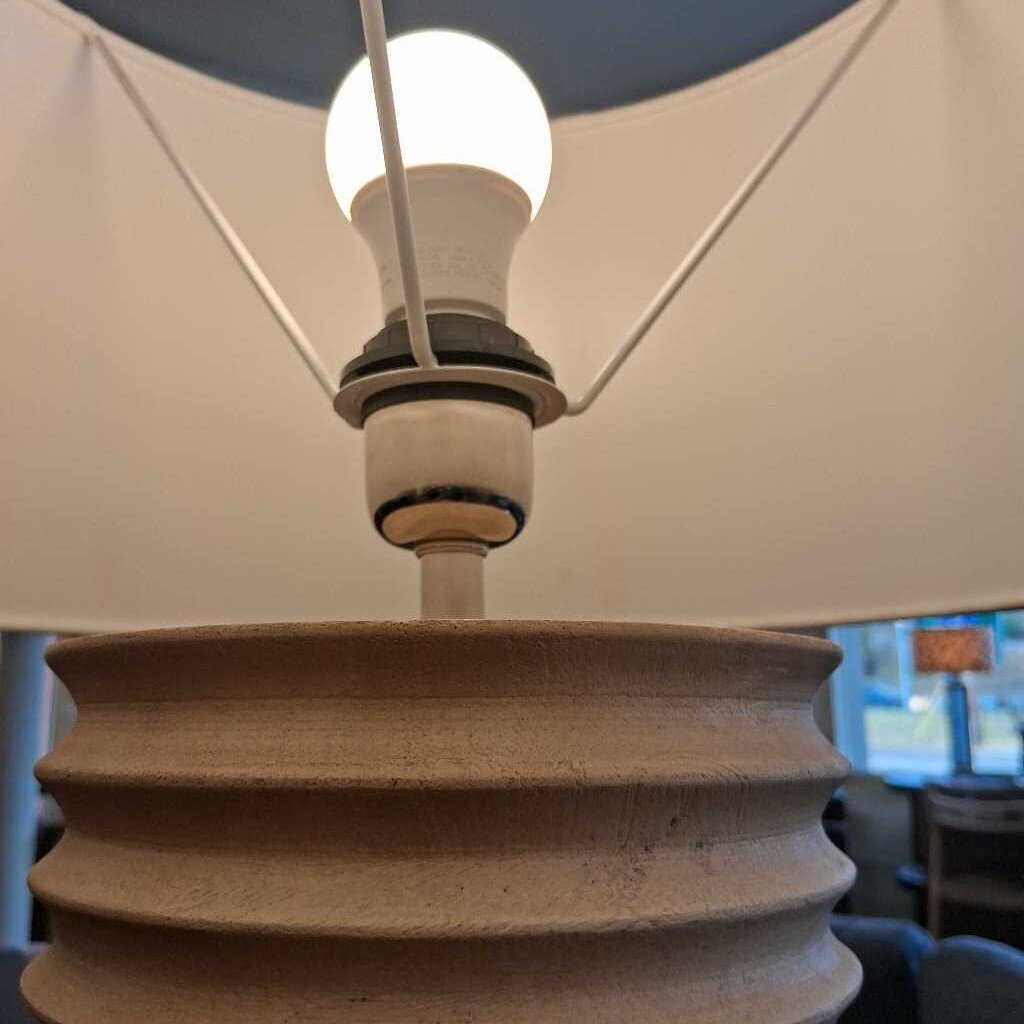 Close-up of a light bulb inside a lampshade with a blurred background