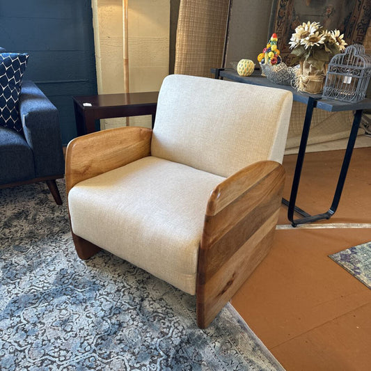 Beige armchair with wooden arms in a room setting