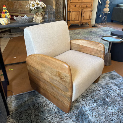 Beige armchair with wooden arms in a living room setting