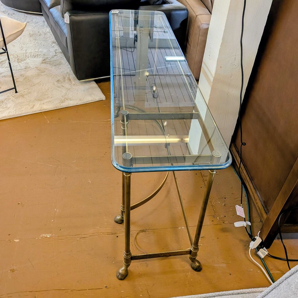 Glass table with metal legs on a wooden floor