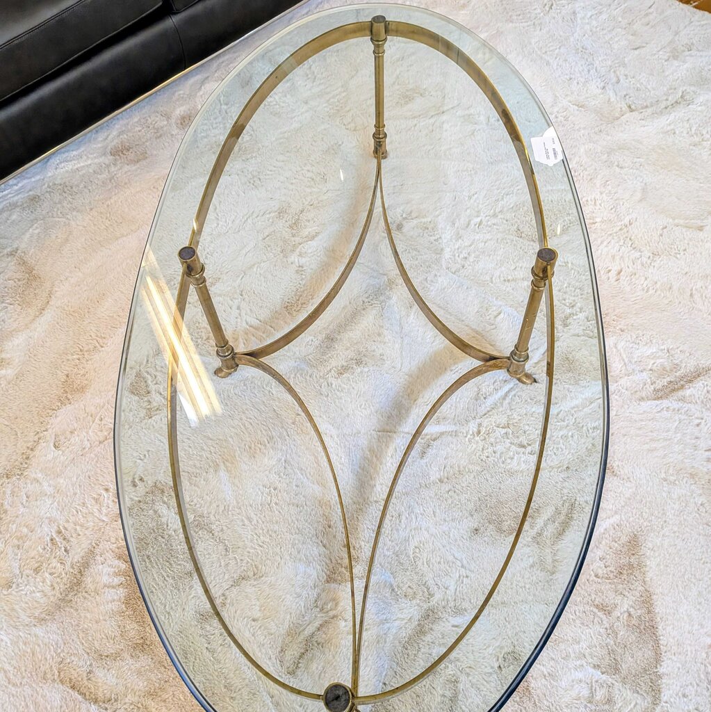 Glass coffee table with metal frame on a marble surface