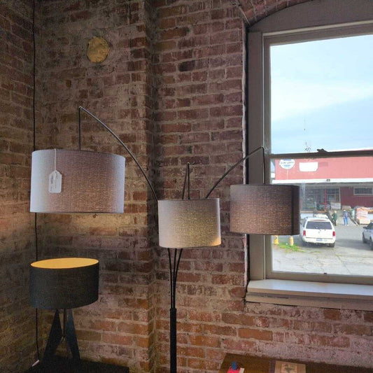 Lamps against a brick wall with a window showing an outside view.