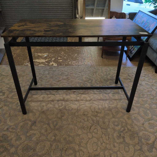 Wooden desk with metal legs on a carpeted floor