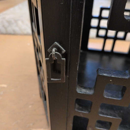 Metallic door handle on a metal gate with a blurred background