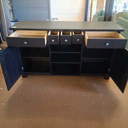 Dark gray sideboard with open doors and drawers on a wooden floor.