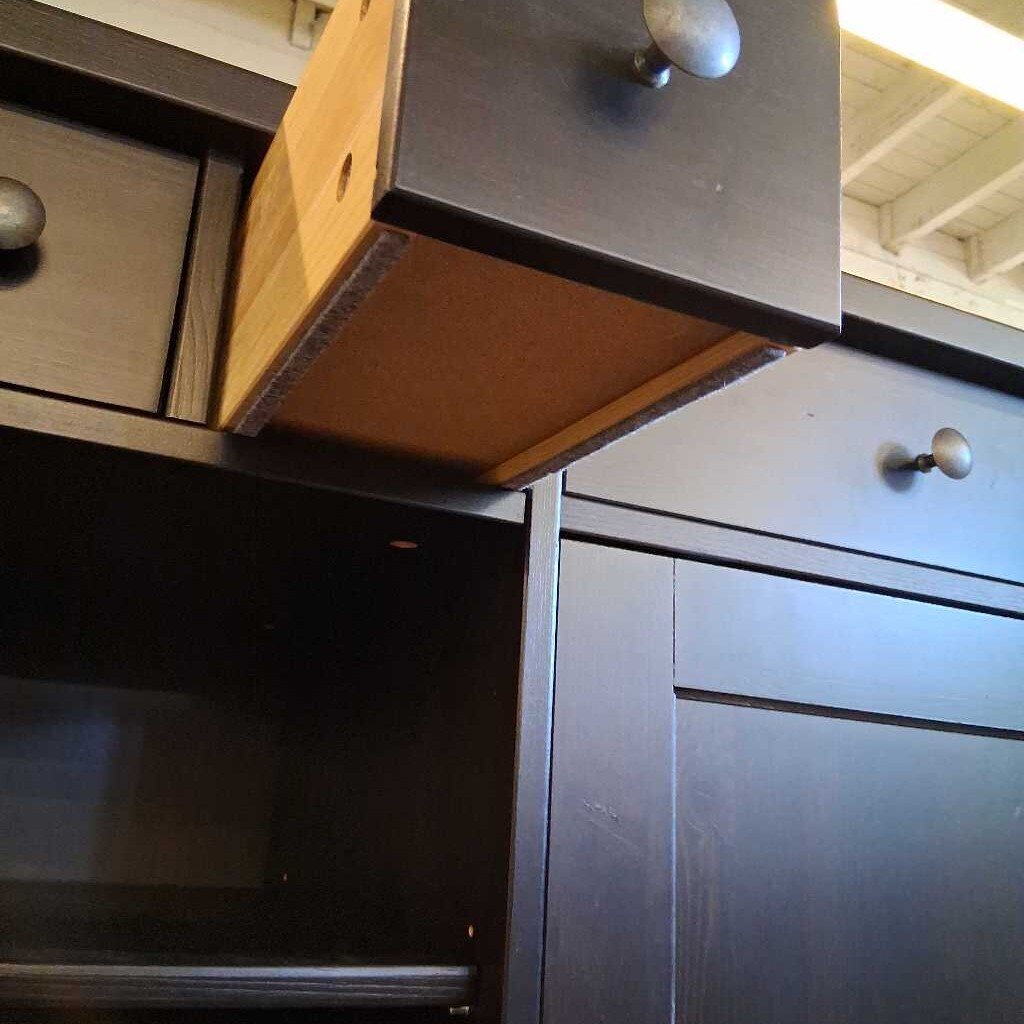 Close-up of a kitchen cabinet with an open drawer