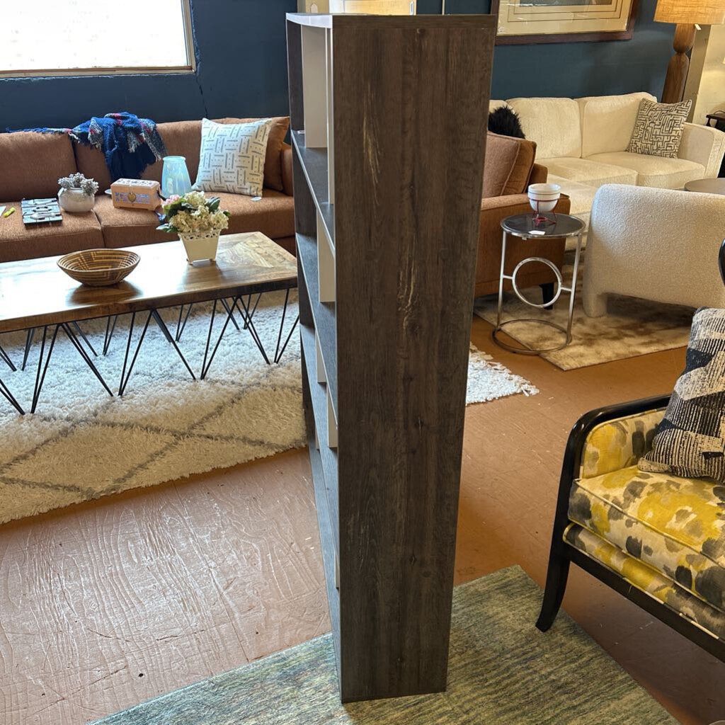 Living room with brown sofa, coffee table, and decorative items.