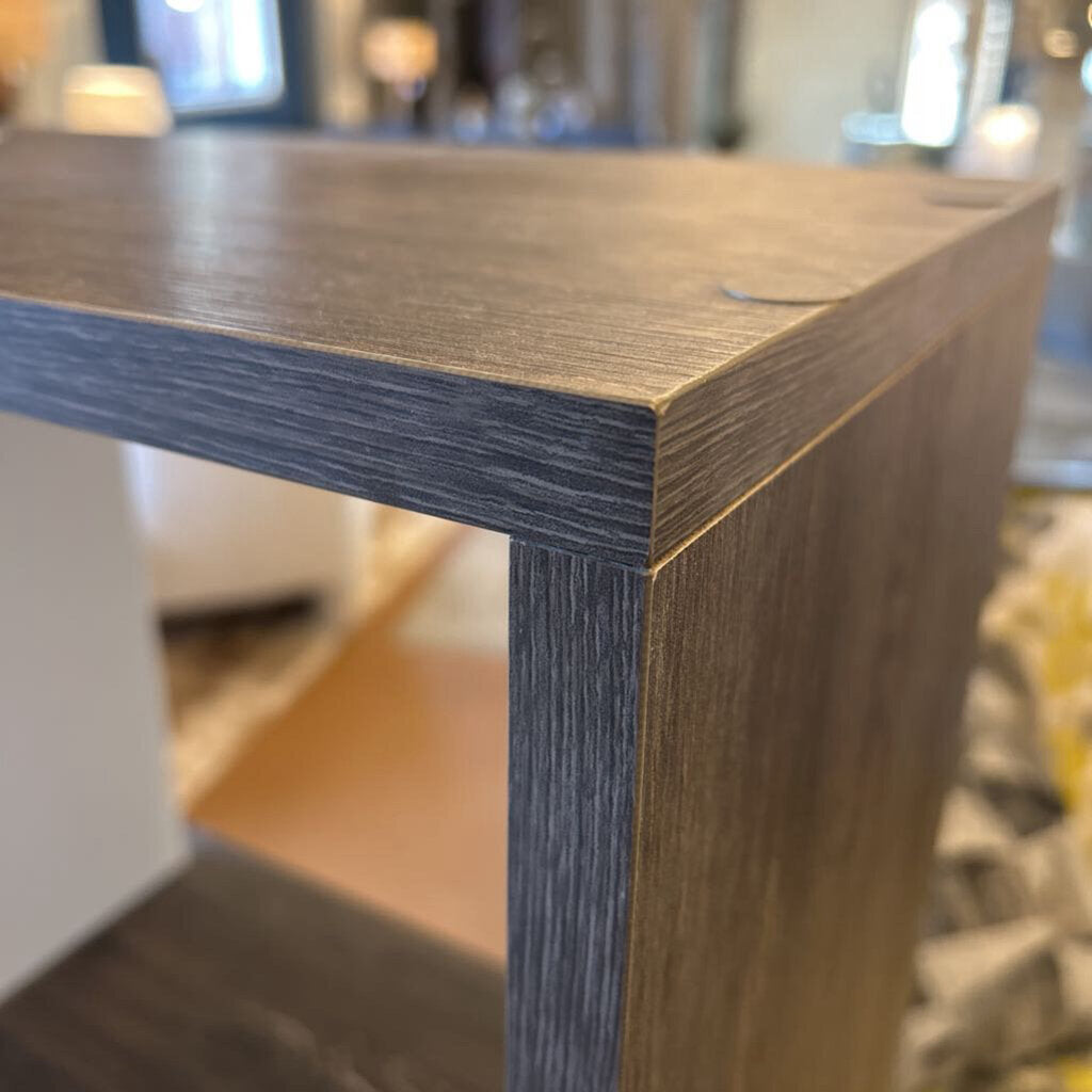 Close-up of a wooden table corner with blurred background