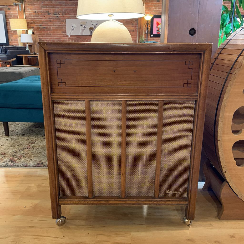 Wooden sideboard with wicker panel in a living room setting