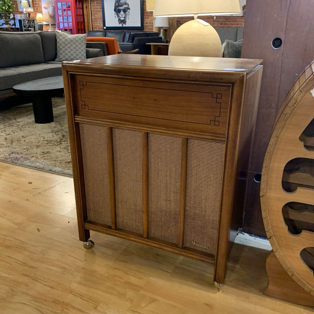 Wooden cabinet with wicker doors in a living room setting