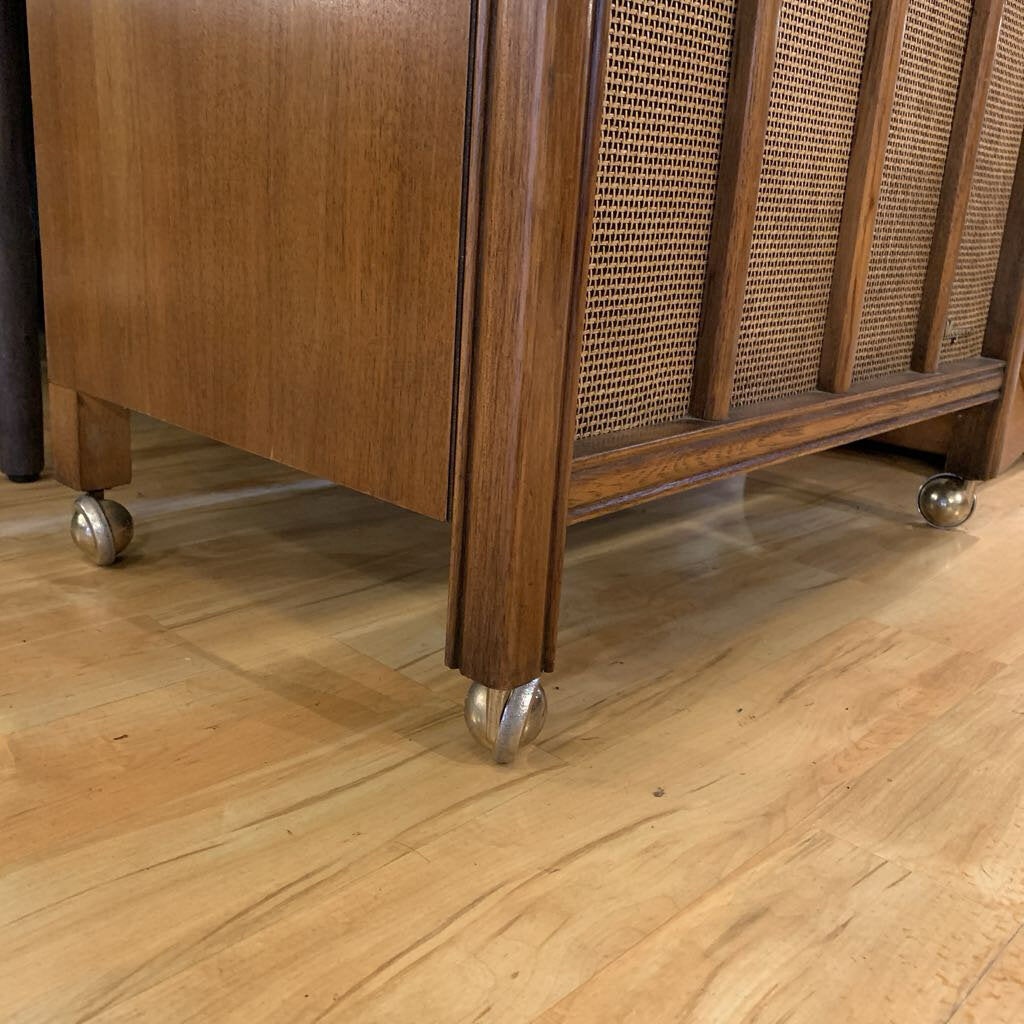 Wooden cabinet with wheels on a wooden floor
