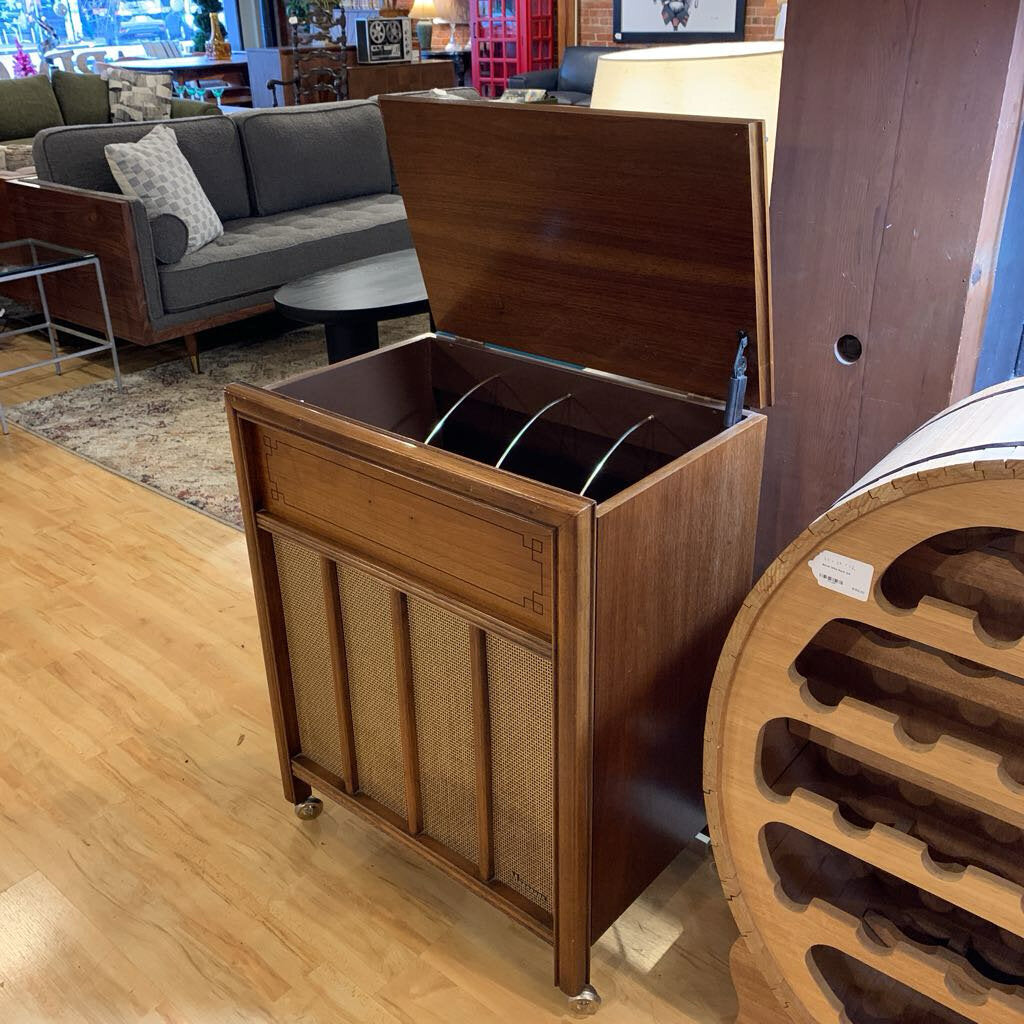 Wooden storage unit with open lid in a room with furniture and decor.