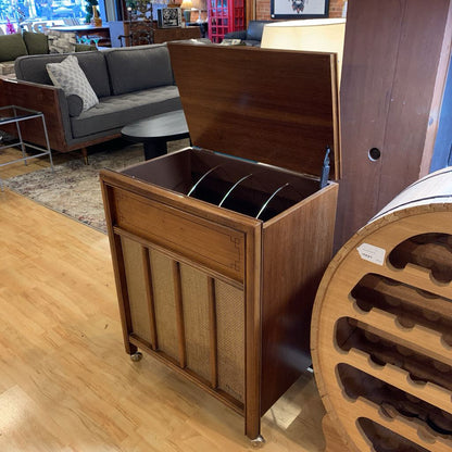 Wooden storage unit with open lid in a room with furniture and decor.