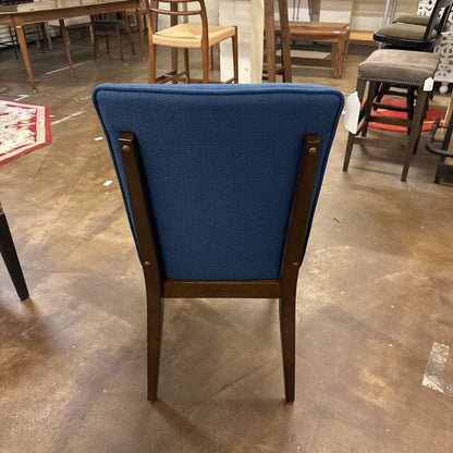 Blue chair with wooden frame on a concrete floor