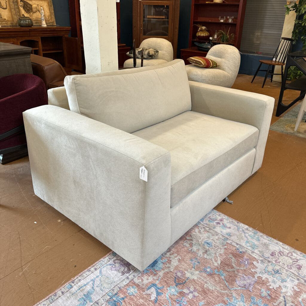 Beige sofa with a price tag in a showroom setting