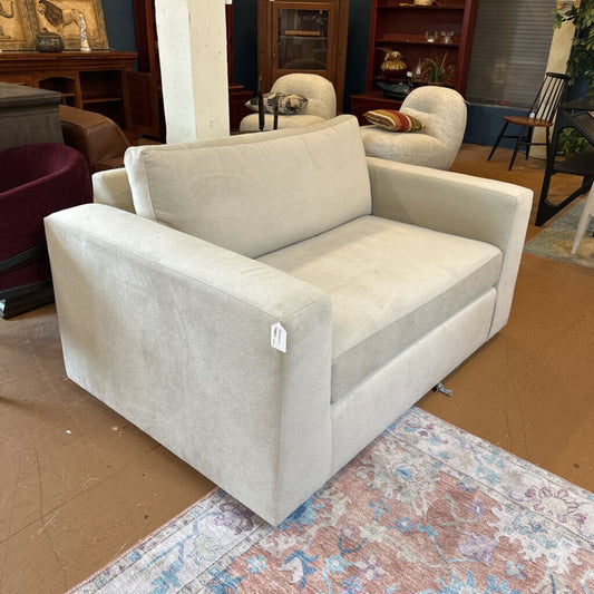 Beige sofa with a price tag in a showroom setting
