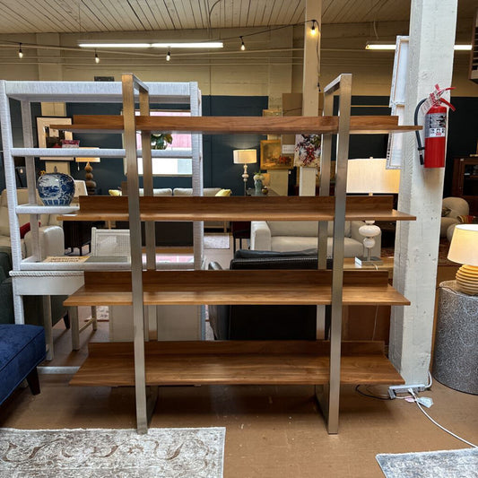 Wooden shelf unit in a store setting with various decor items.
