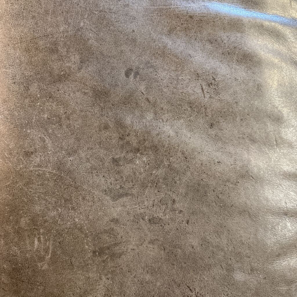 Close-up of a textured brown surface with a blue object in the corner